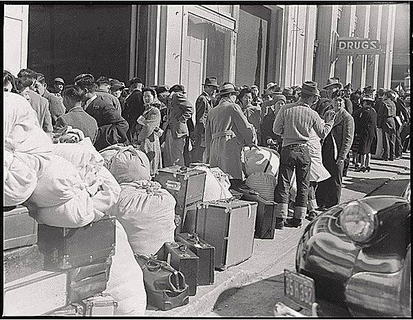 Japanese-waiting-On-Van-Ness-to-be-transported-to-camps-1942-by-Dorothea-Lange-via-FB.jpg