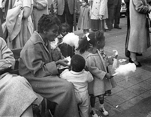 Young-black-mom-and-kids-at-playland-with-cotton-candy.jpg